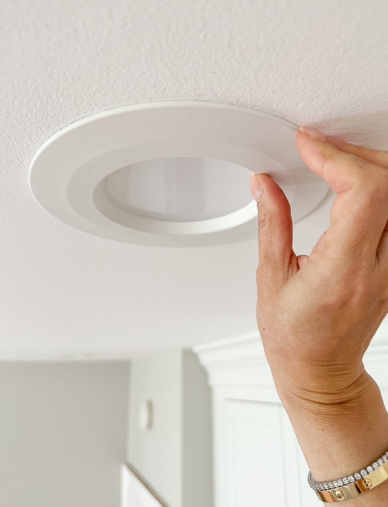 person showing recessed light flush in the ceiling