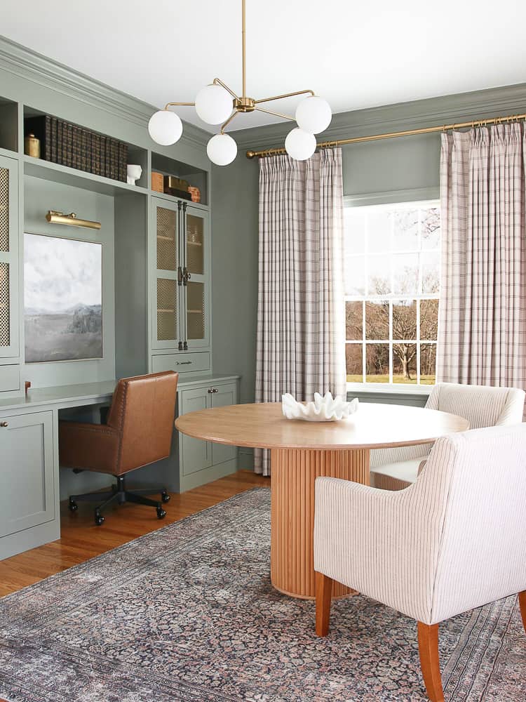 home office with BM Storm Cloud gray paint, patterned linen drapes, builtin cabinets and desk, antique brass hardware, dining room table as desk