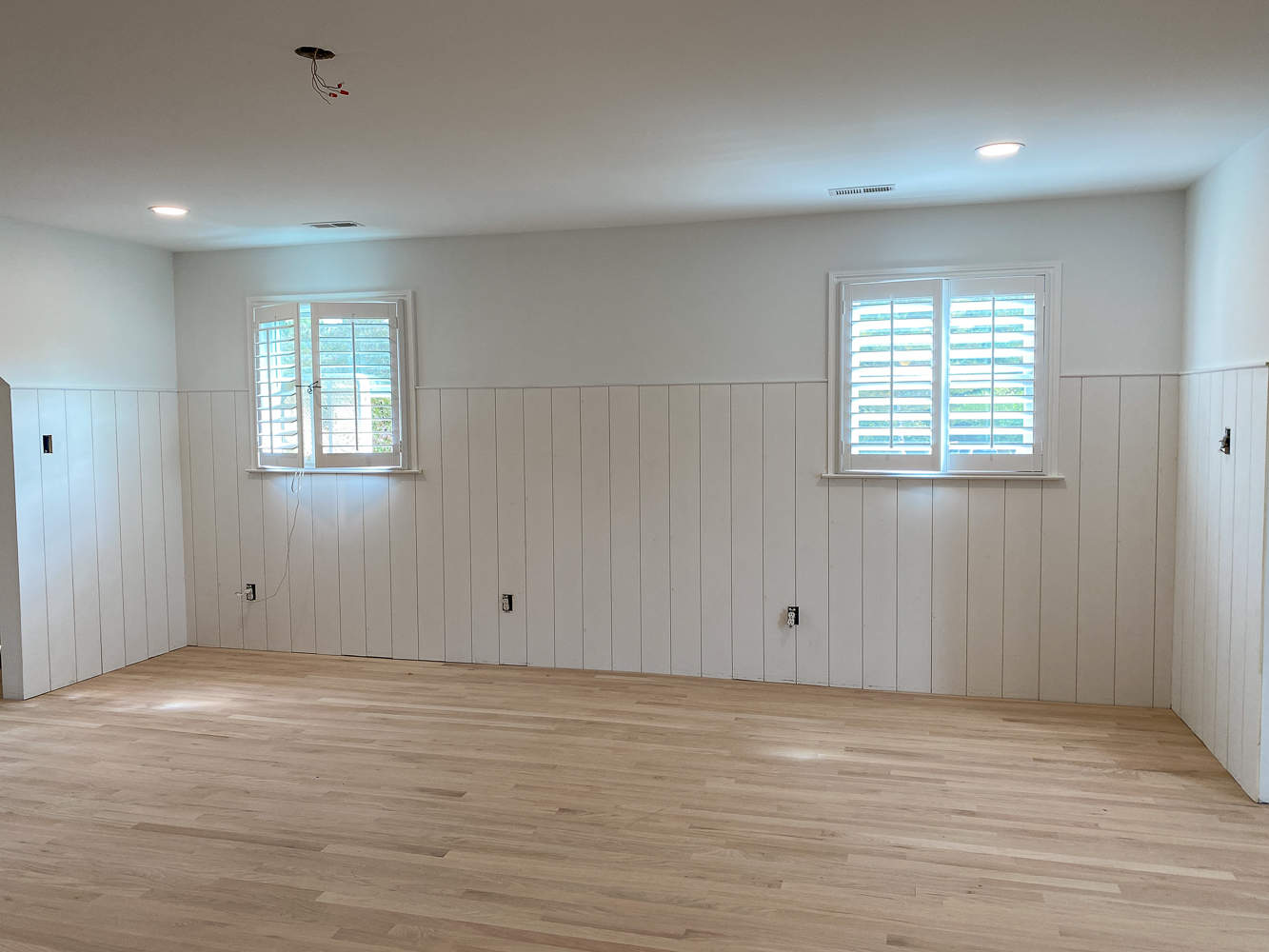 unfinished room with raw red oak floors, unstained