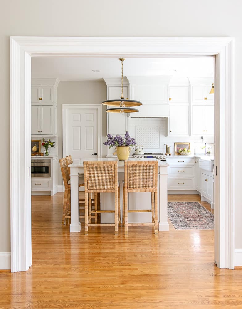 white kitchen with red oak wood floors, unlacquered brass kitchen hardware, custom inset cabinets