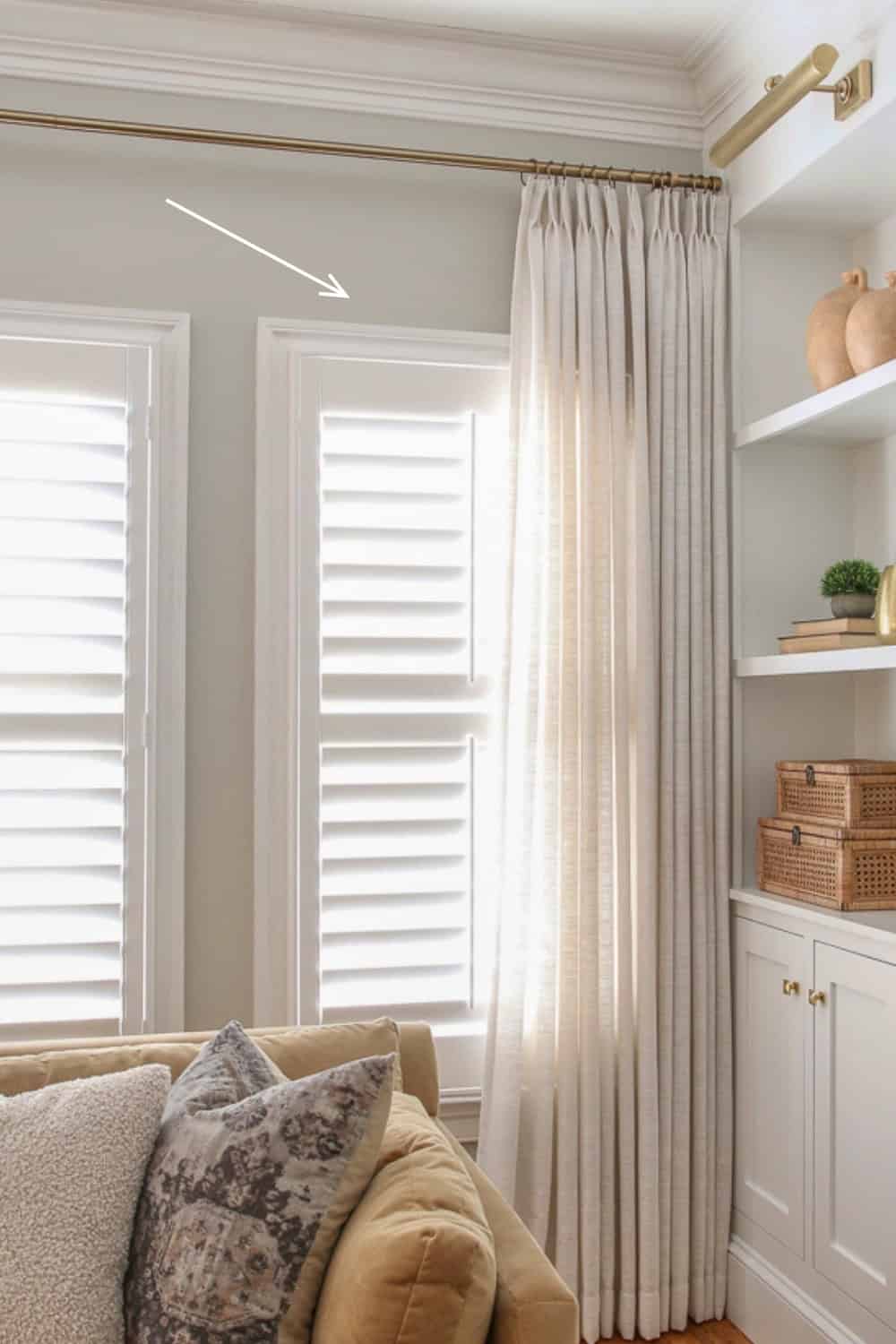 living room with traditional crown molding and window casings, agreeable gray paint